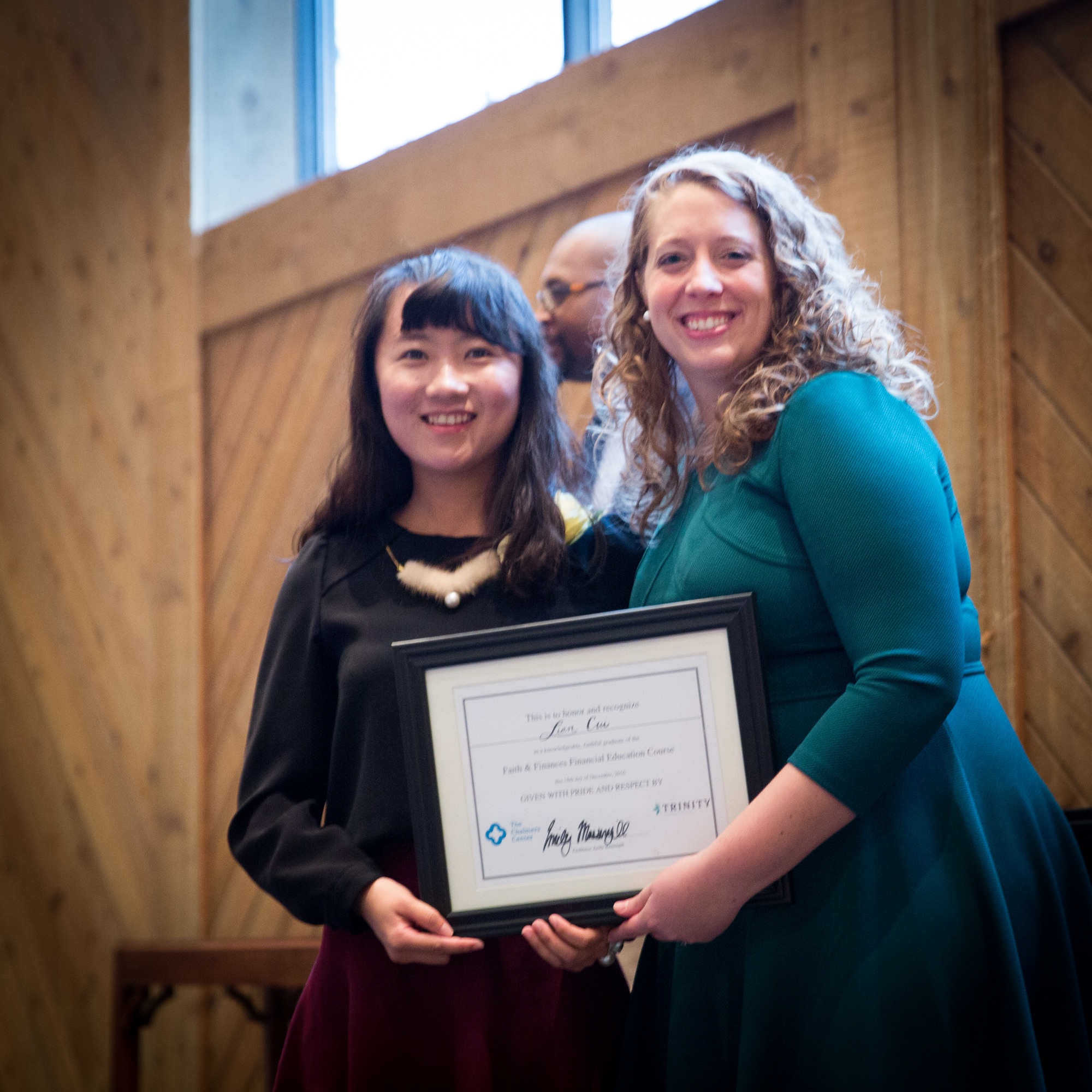 A Faith and Finances graduate receiving her certificate