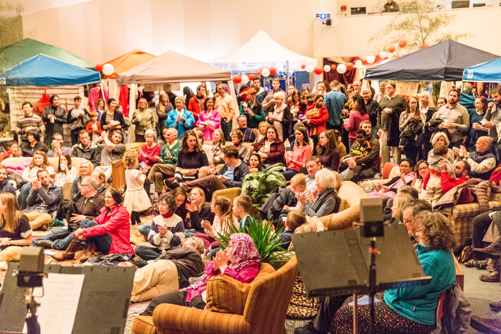 A crowd gathered among market tents at Taste and See