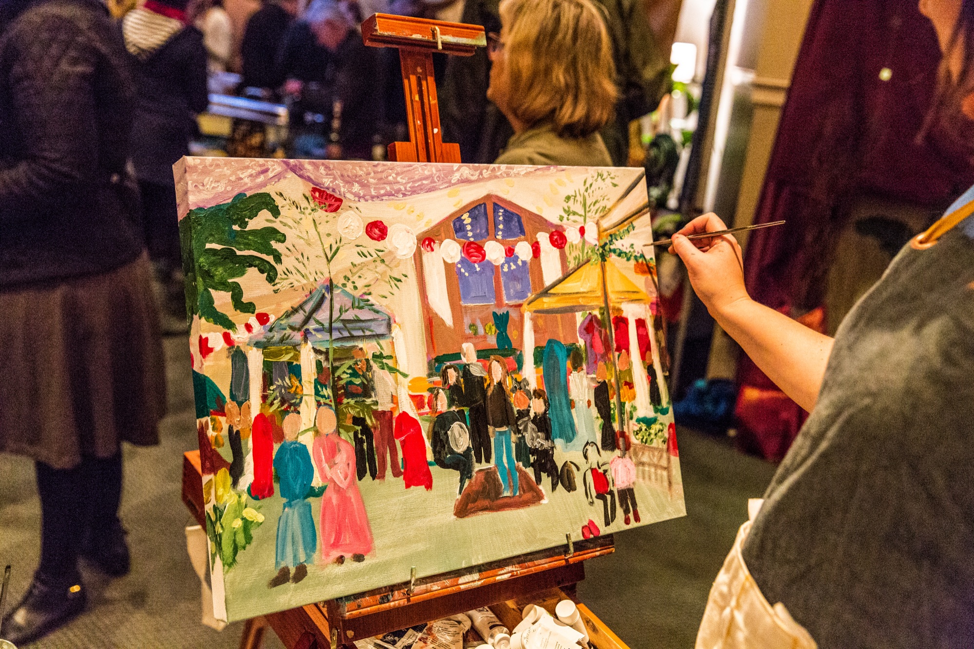 An artist painting a live scene of Taste and See